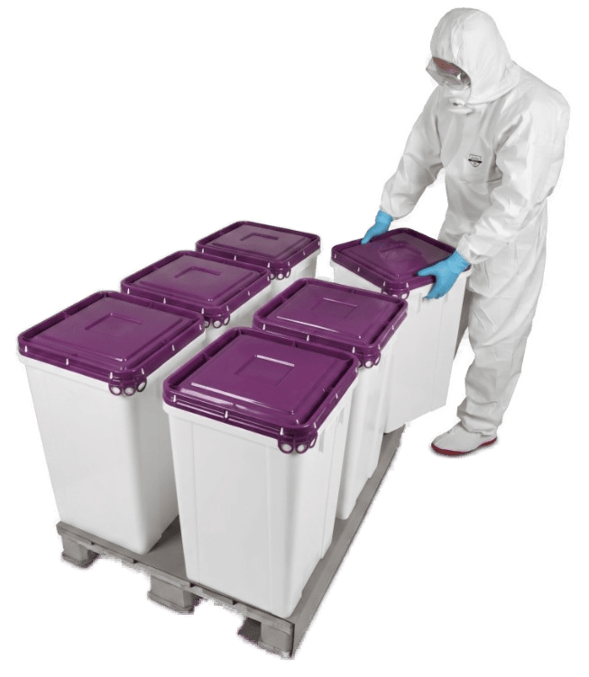 Worker in protective gear arranging purple-lid Darbox containers on a pallet